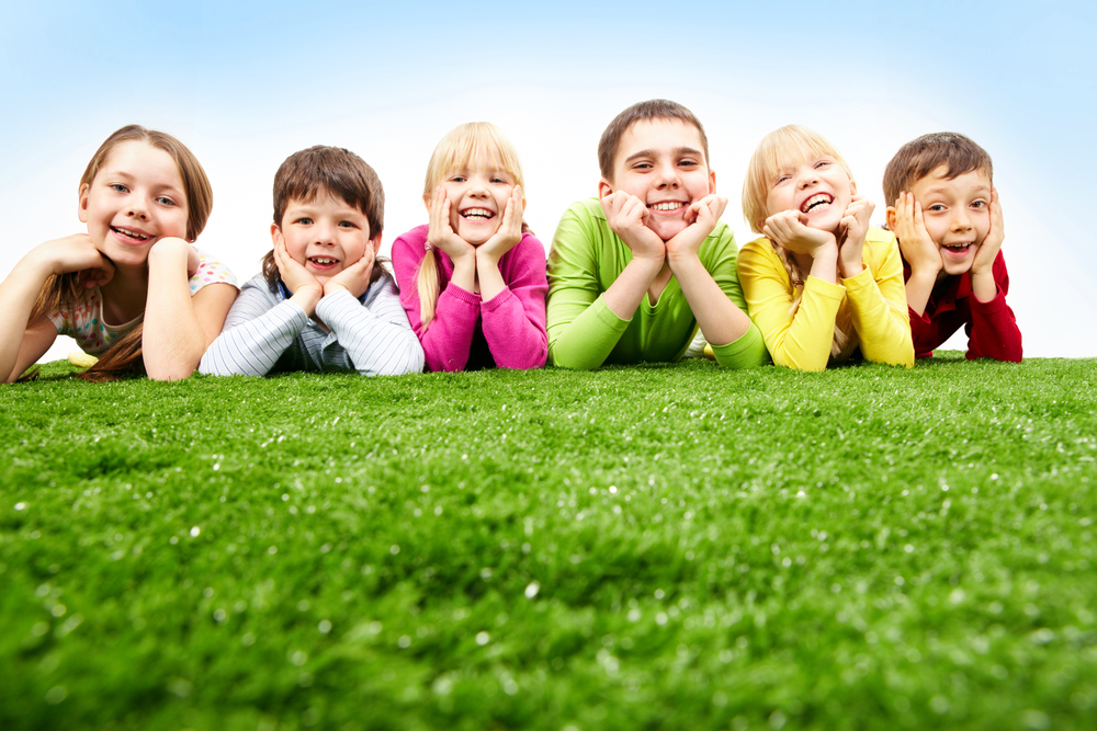 Kids laying on artificial grass in Fresno, California